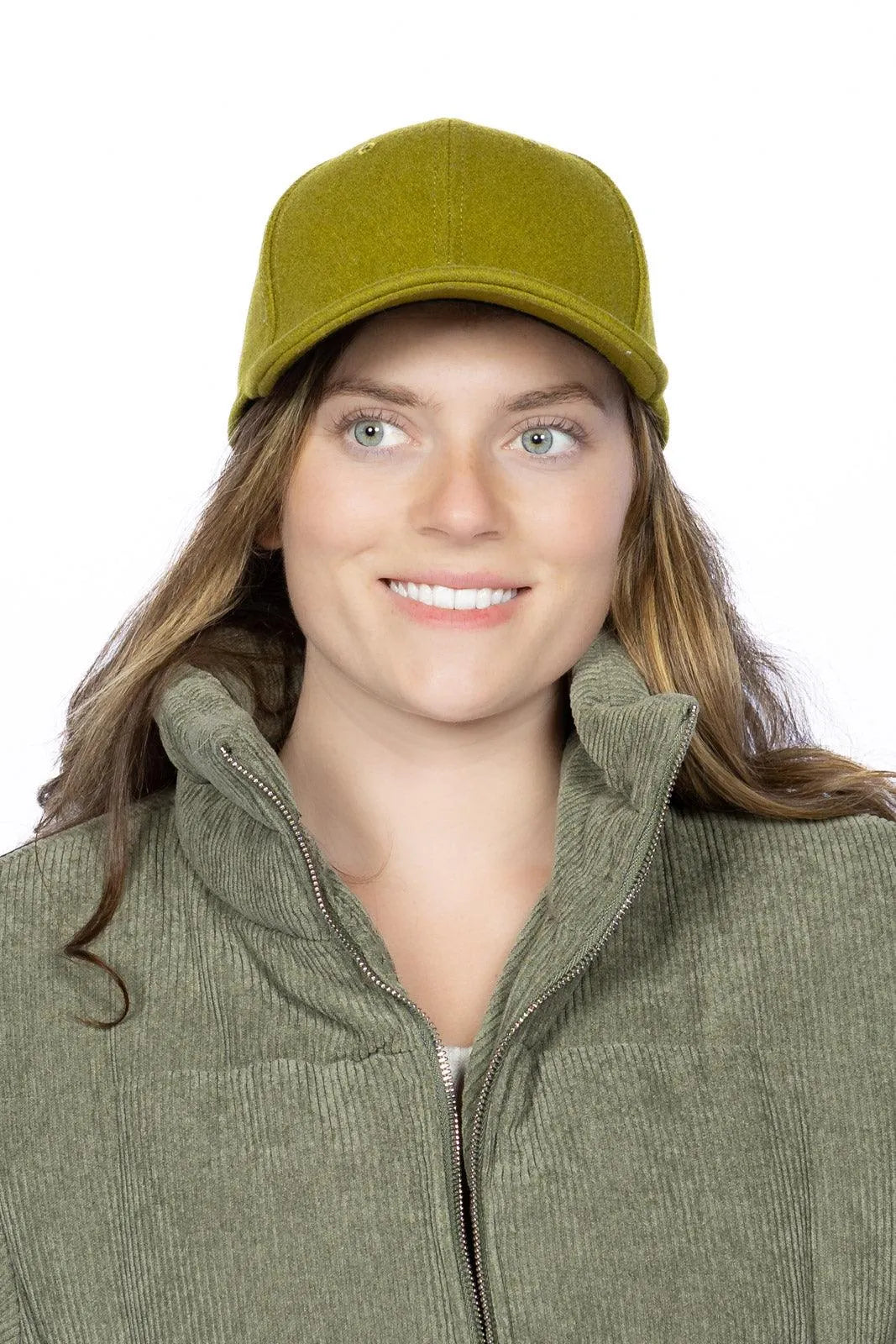 Woman wearing a green cap and matching jacket on a white background