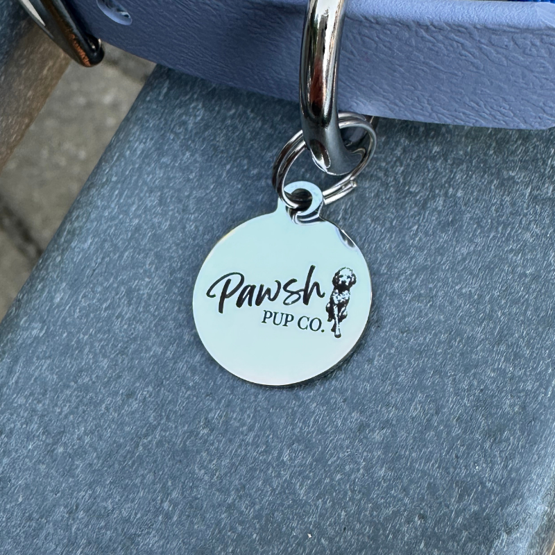 Dog tag with 'Pawsh Pup Co.' on a blue background