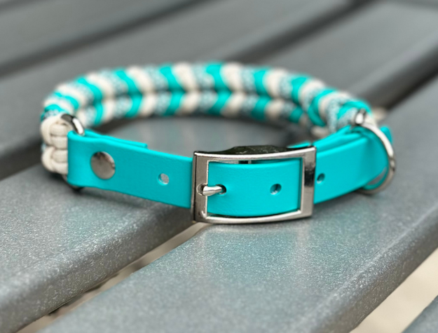 Teal dog collar with striped pattern on a gray surface