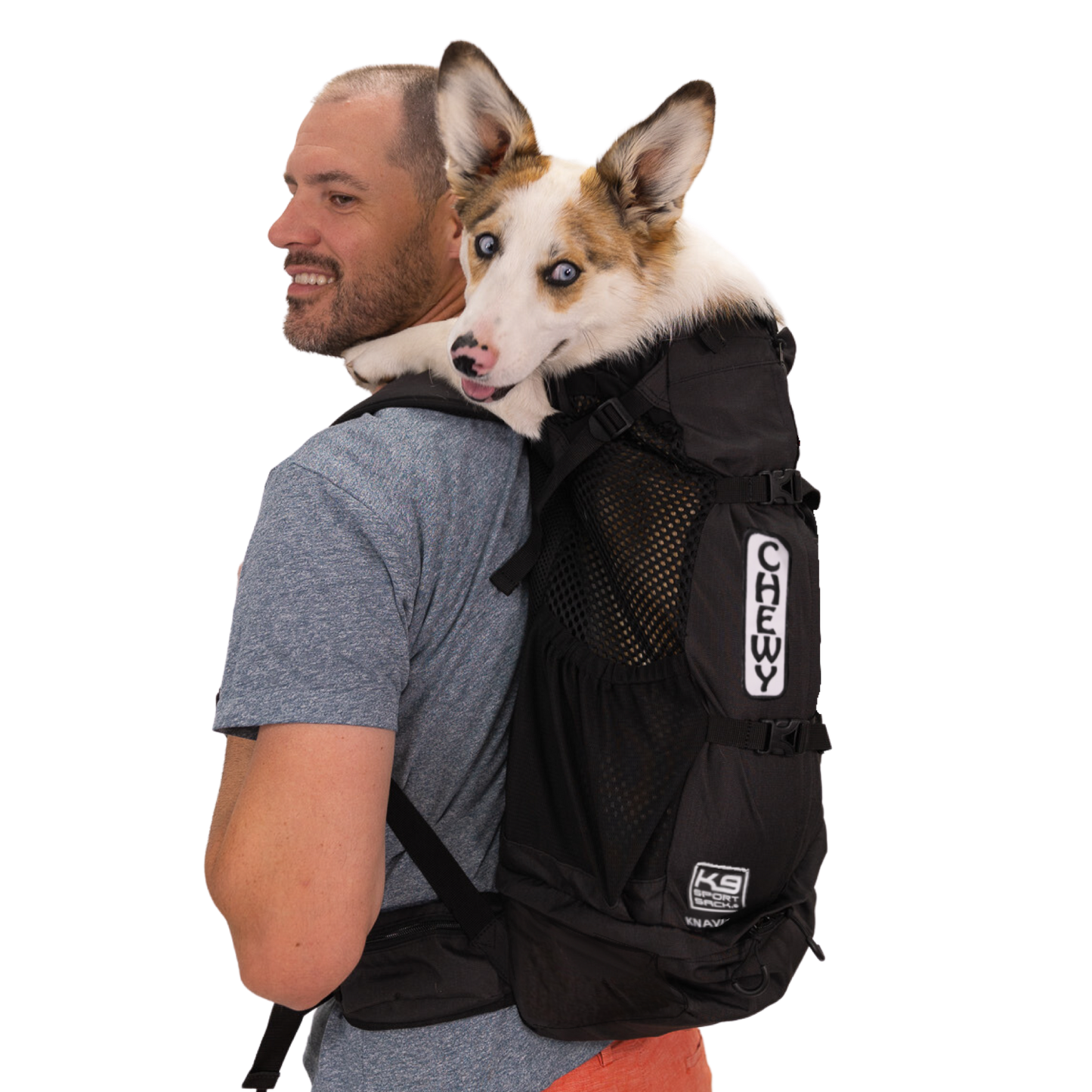 Man carrying a dog in a black backpack with 'K9s' branding on a white background