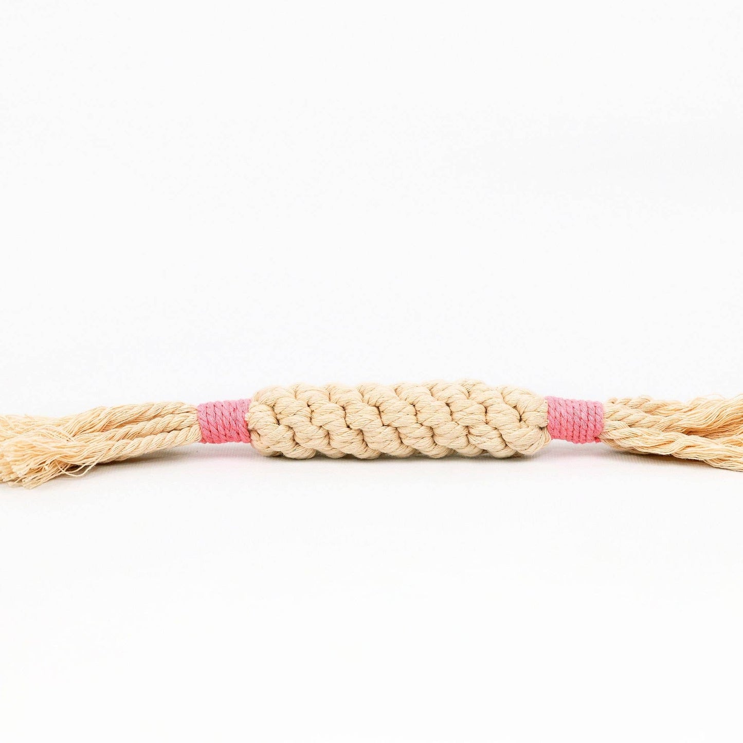 Braided toy rope with a pink center on a white background