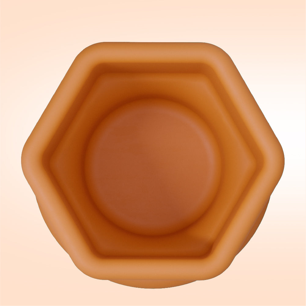 Hexagonal brown pot on a beige background