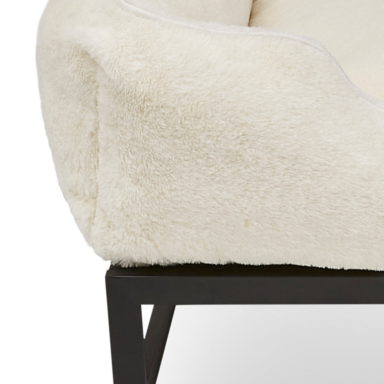 Close-up of a chair with a fluffy beige cushion and black metal frame on a white background