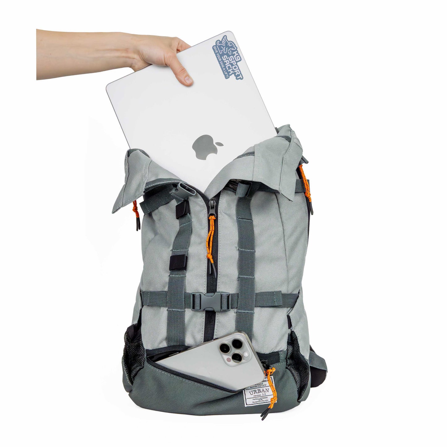 Gray backpack with a laptop and phone, held by a hand on a white background