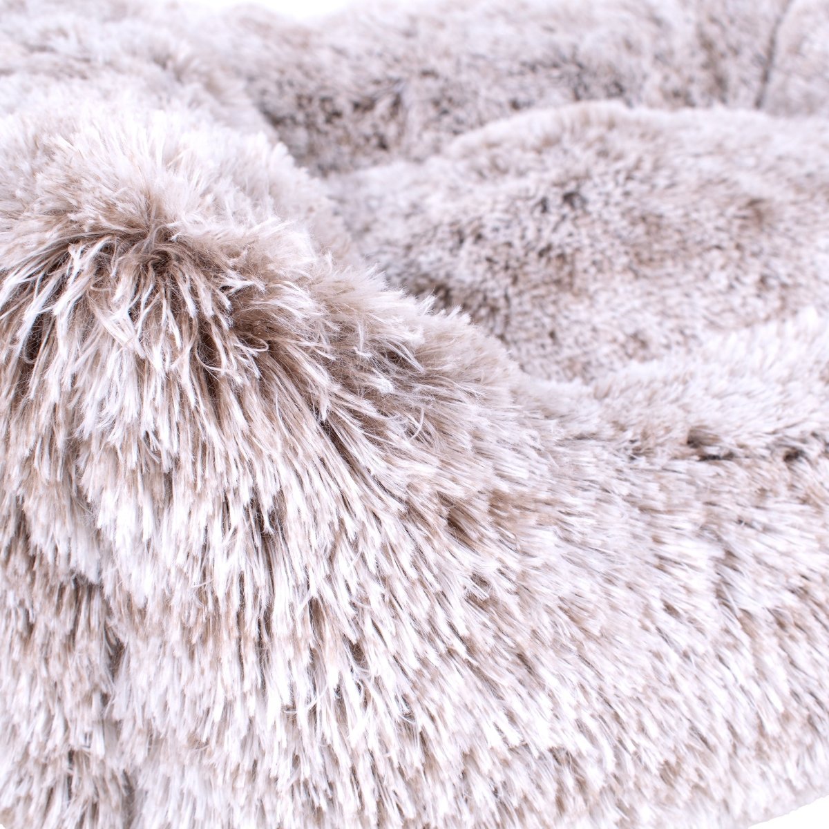 Close-up of a fluffy, light brown and white fabric texture