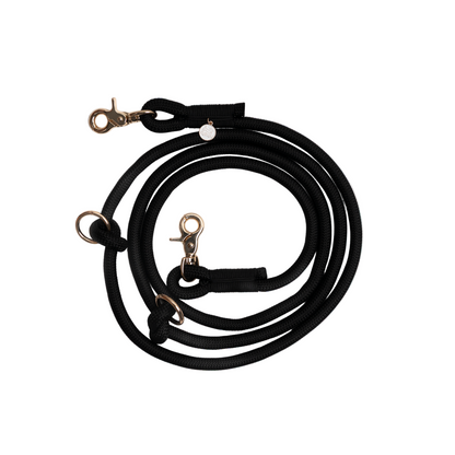Black dog leash with gold clasp on a white background