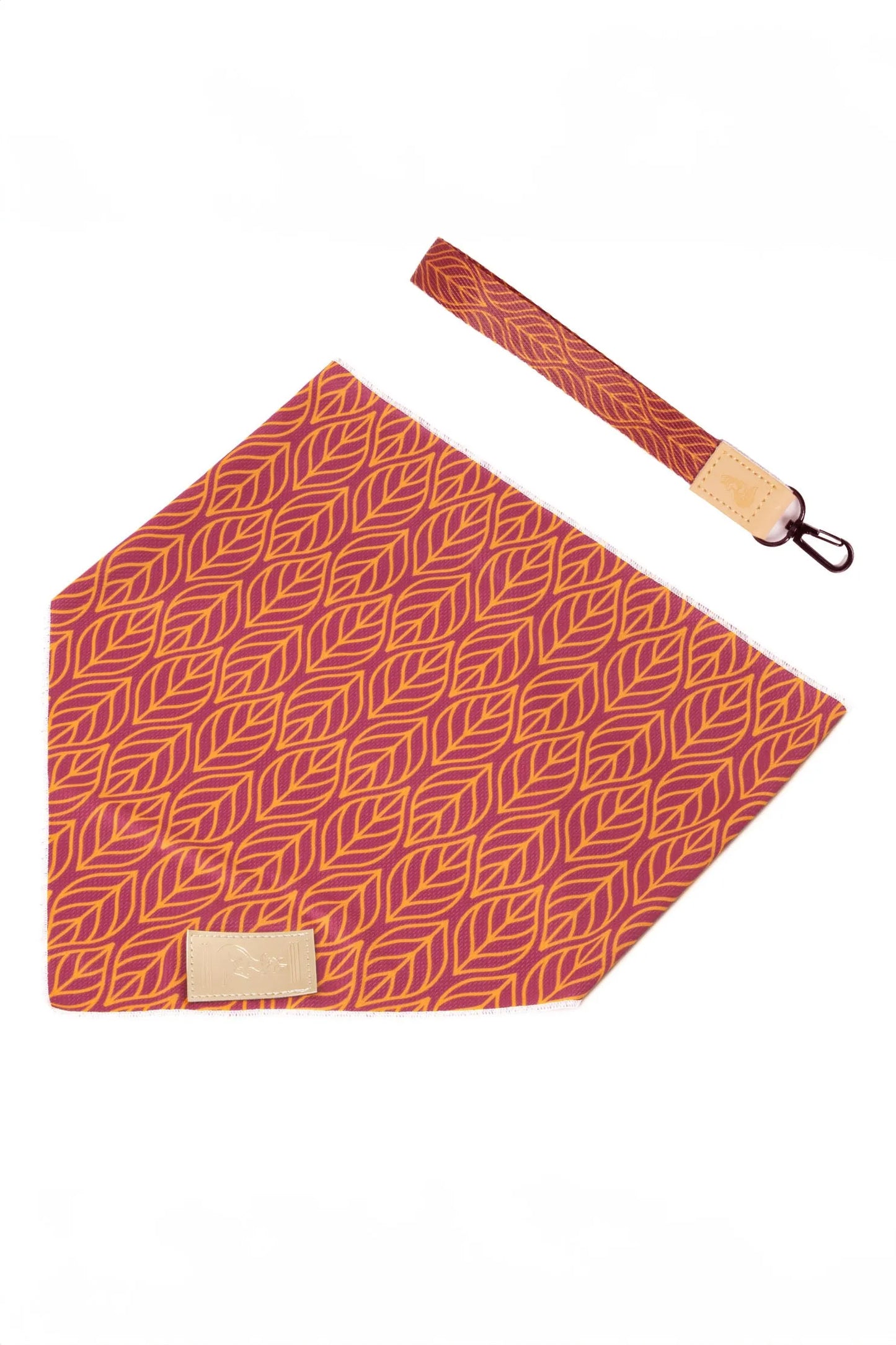 Red patterned bandana with a matching strap on a white background