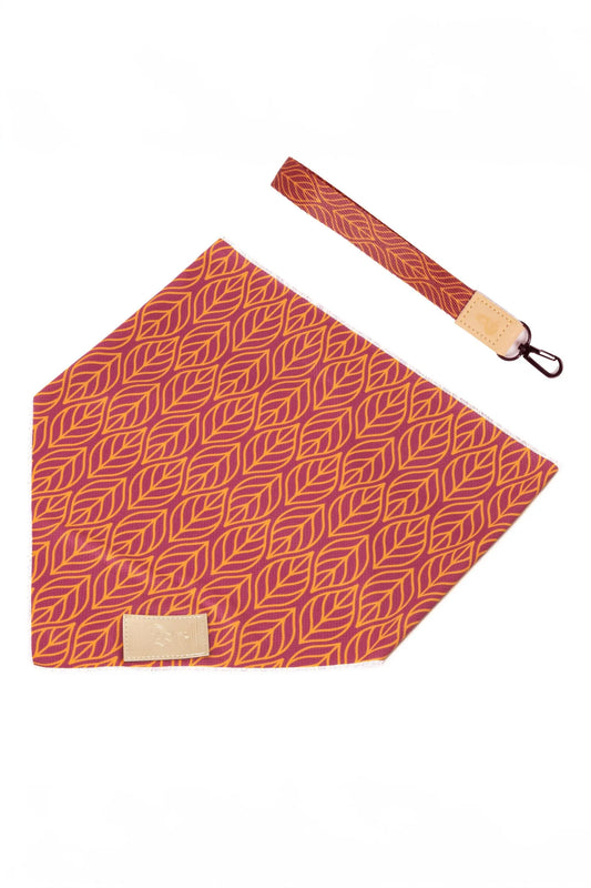 Red patterned bandana with a matching strap on a white background