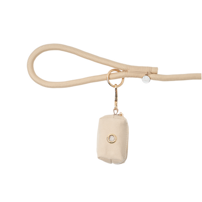 Beige handbag with a matching strap on a white background
