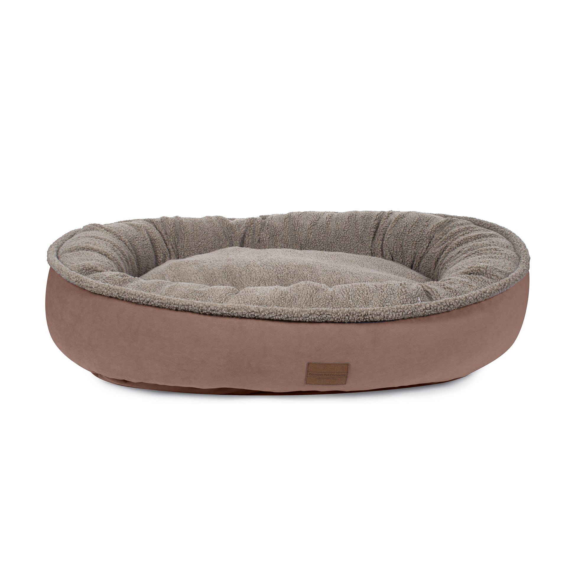 Dog bed with brown exterior and gray interior on a white background