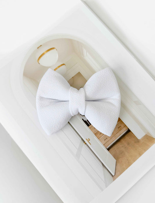 White dog bow tie on a white background