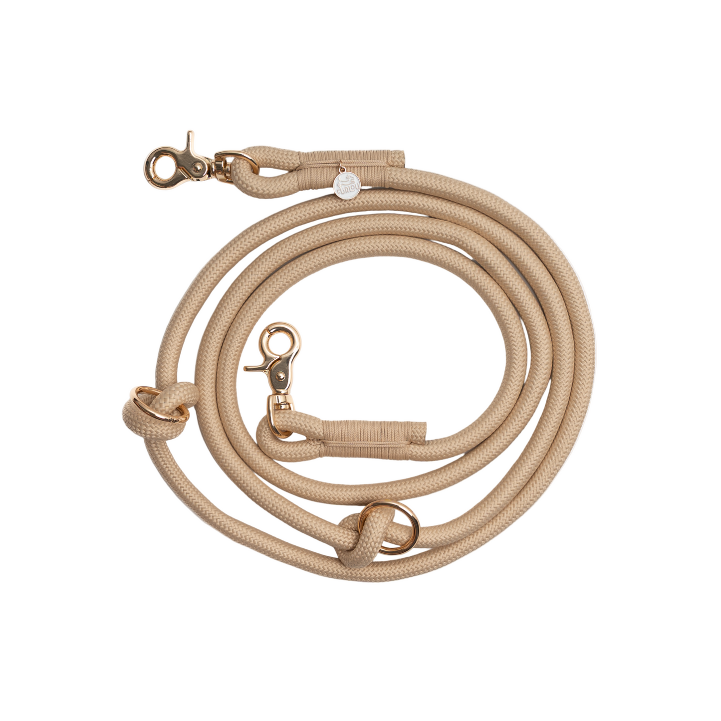 Beige dog leash with gold hardware on a white background