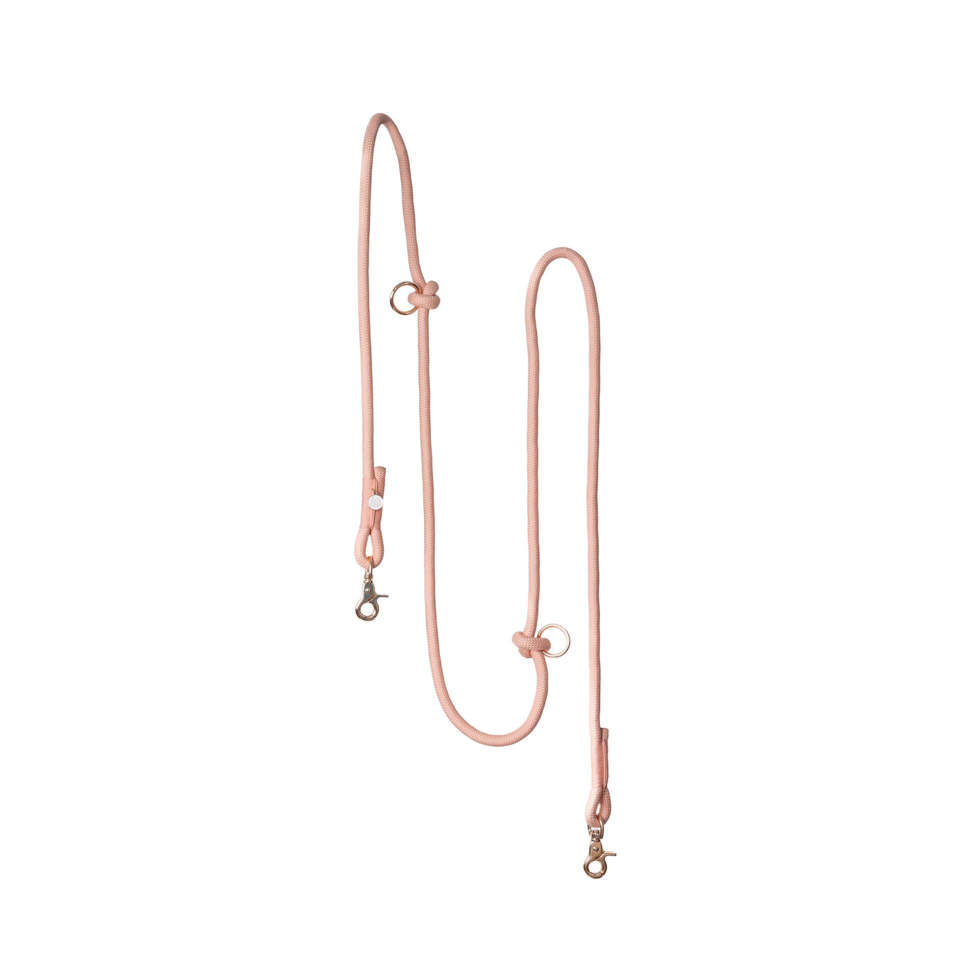 Rose gold dog leash on a light pink background