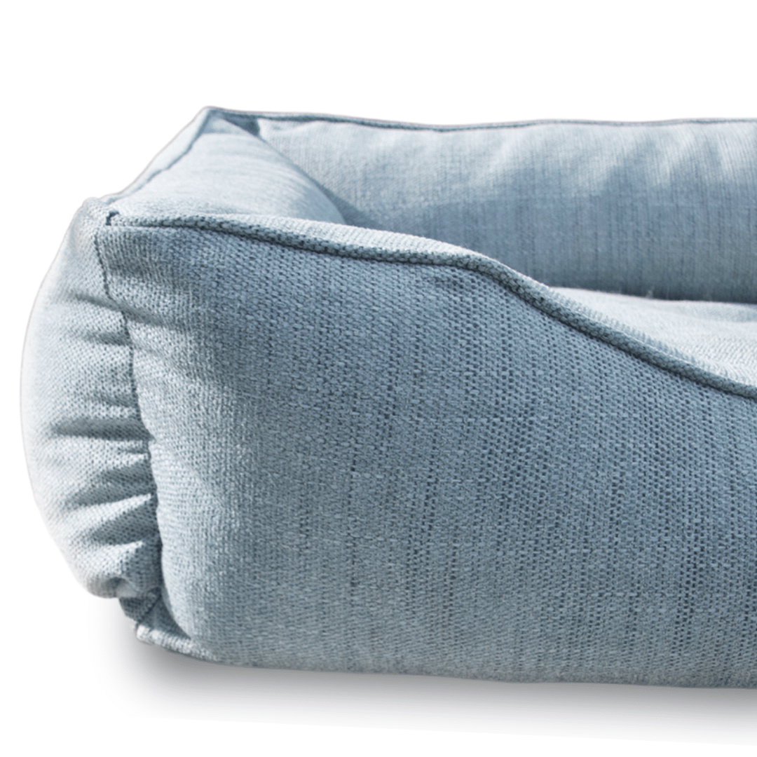 Close-up of a light blue pet bed on a white background