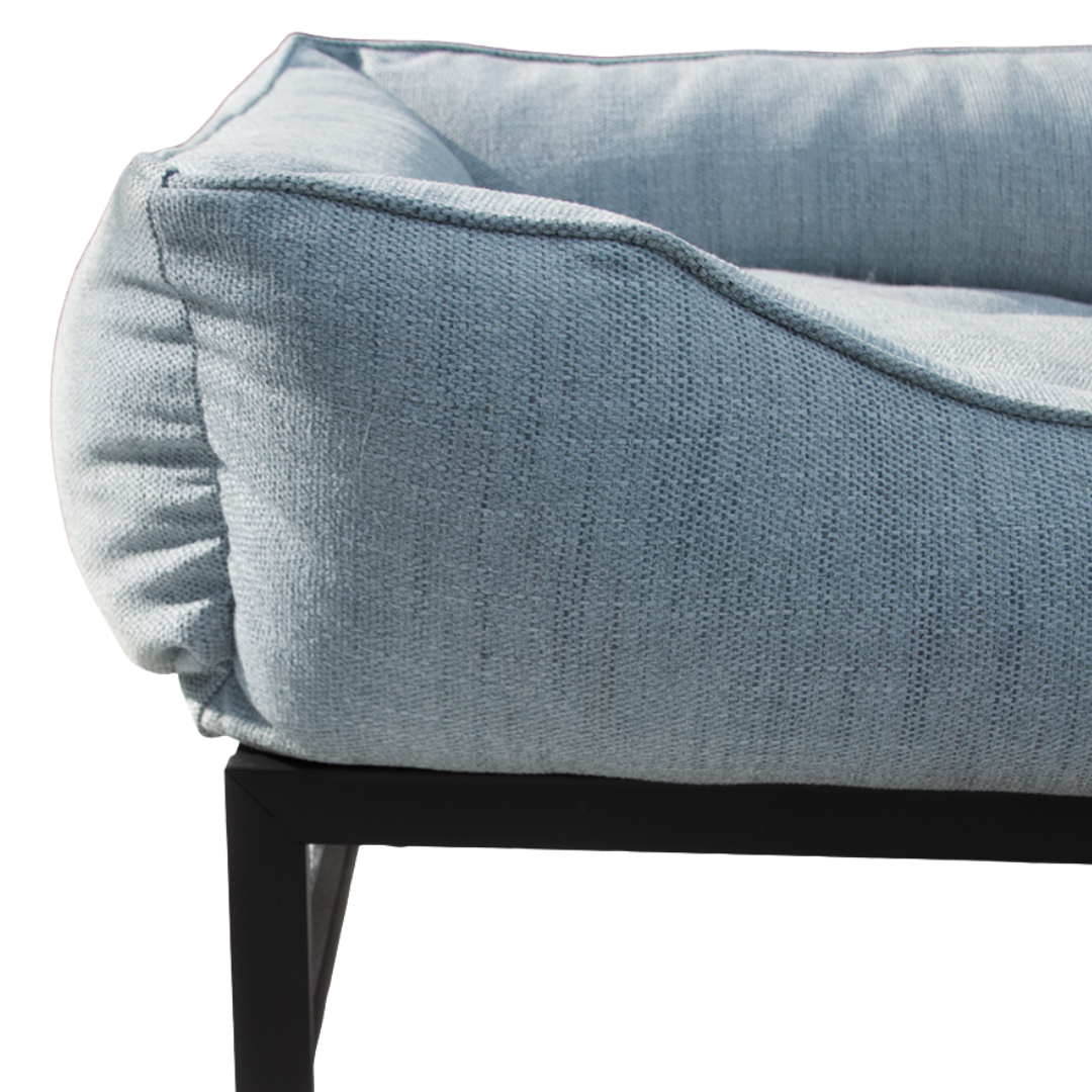 Close-up of a textured blue cushion on a chair with a white background