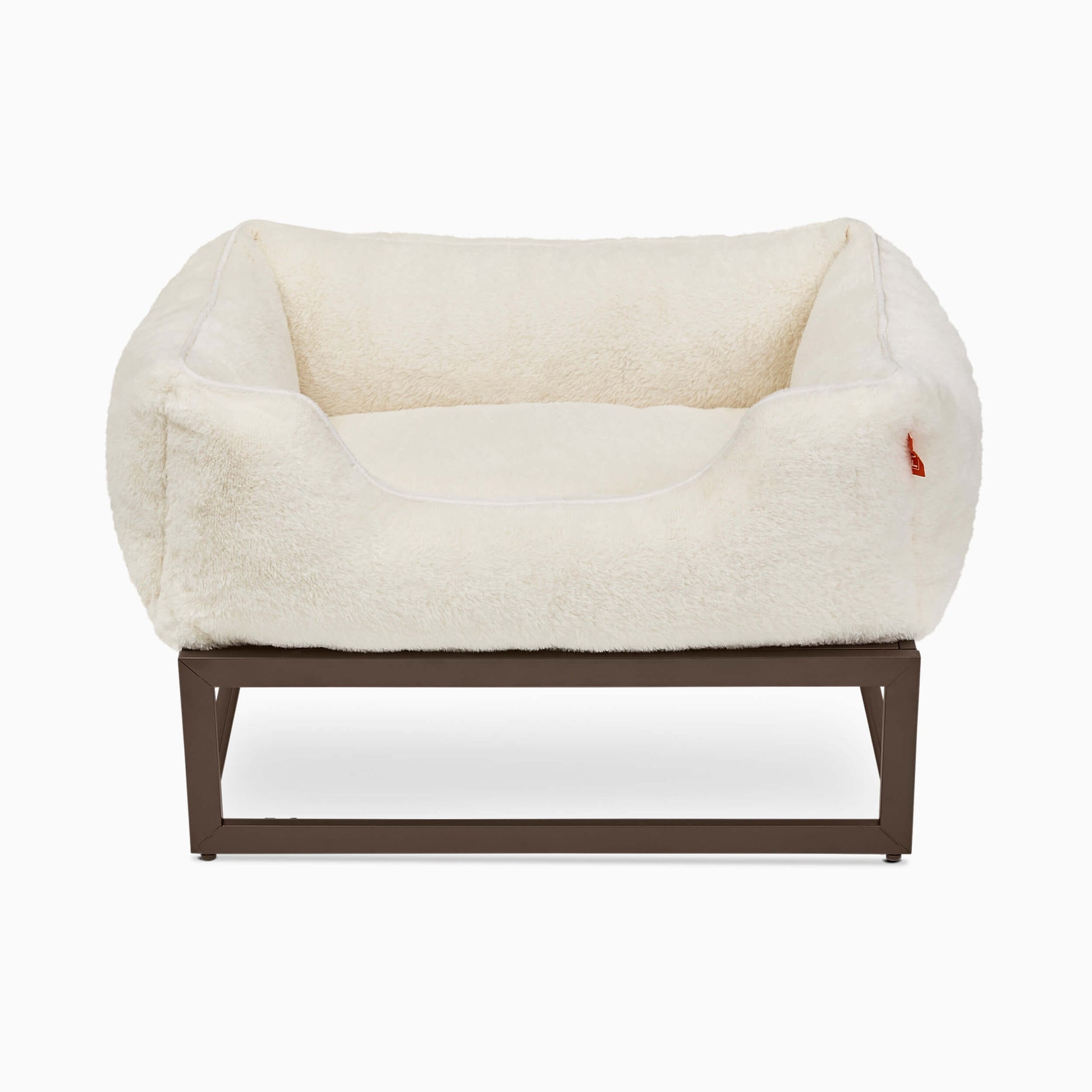 White pet bed with brown frame on a white background