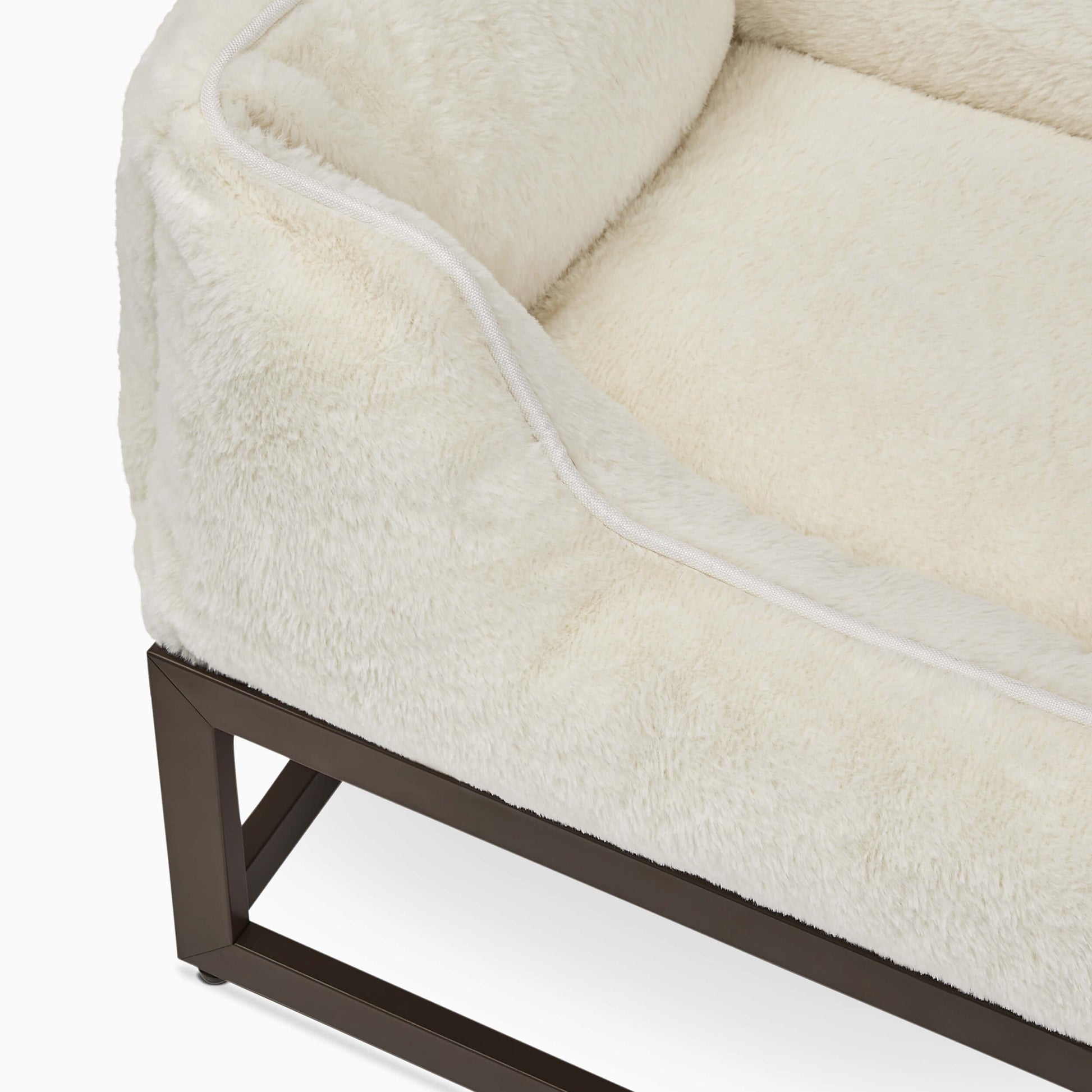 Close-up of a beige cushioned chair with a metal frame on a white background
