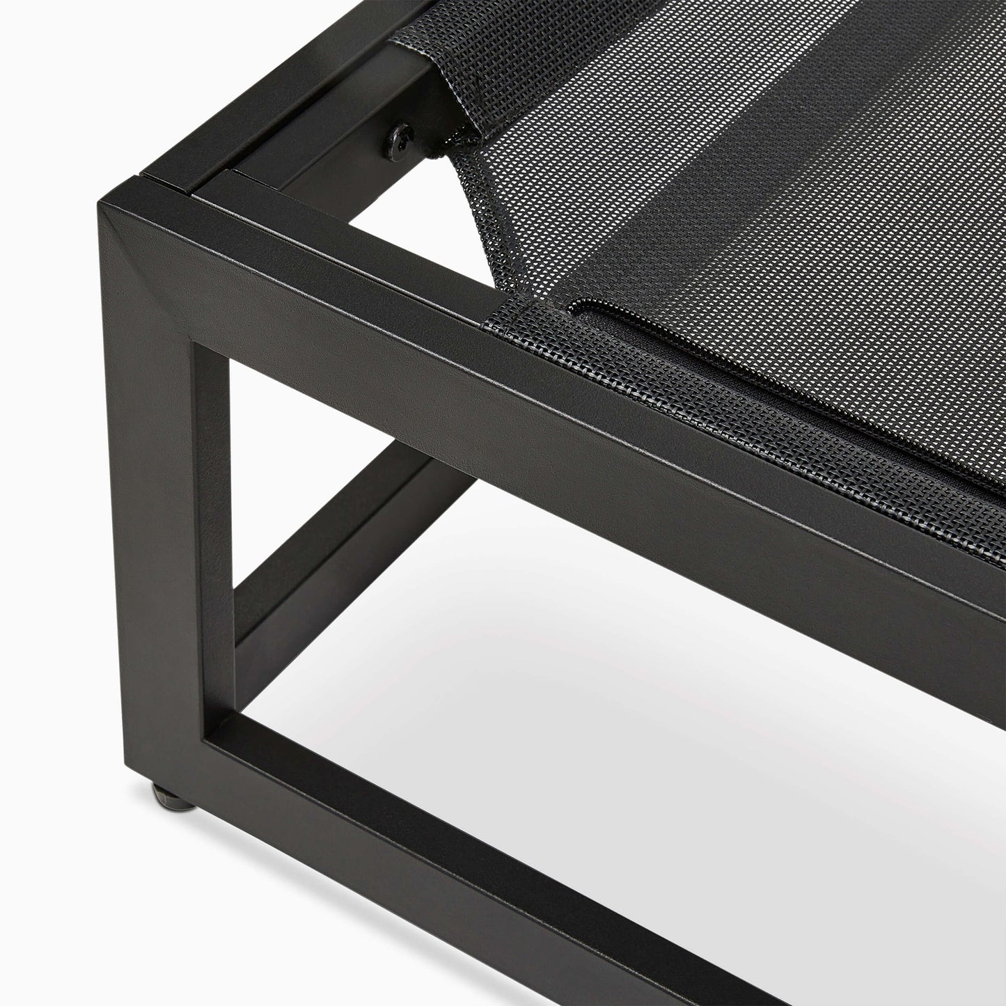 Close-up of a black metal chair with a textured black cushion on a white background