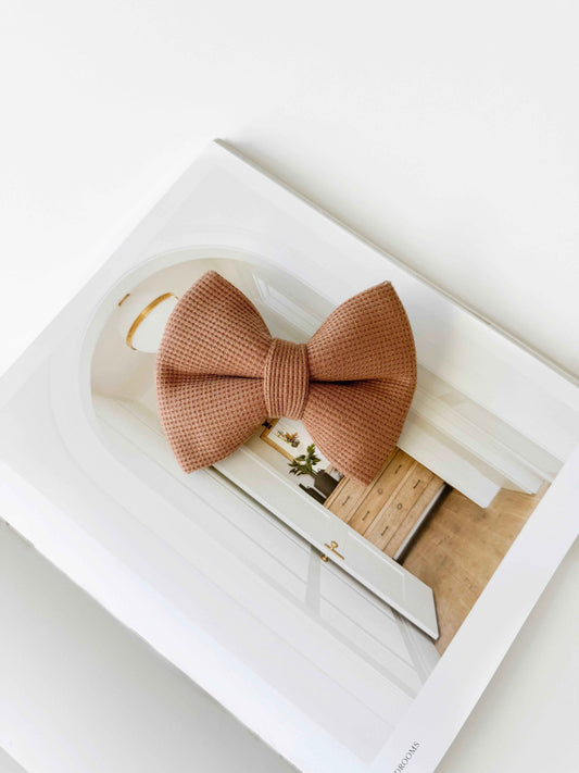 Brown bow tie on a magazine with a blurred background