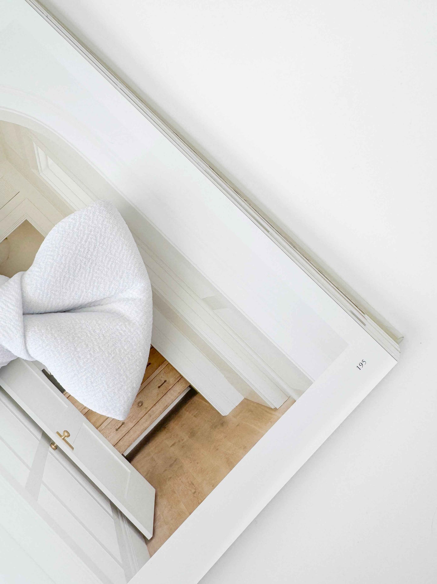 White dog bow on a wooden frame