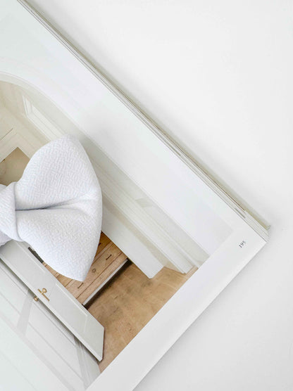 White dog bow on a wooden frame
