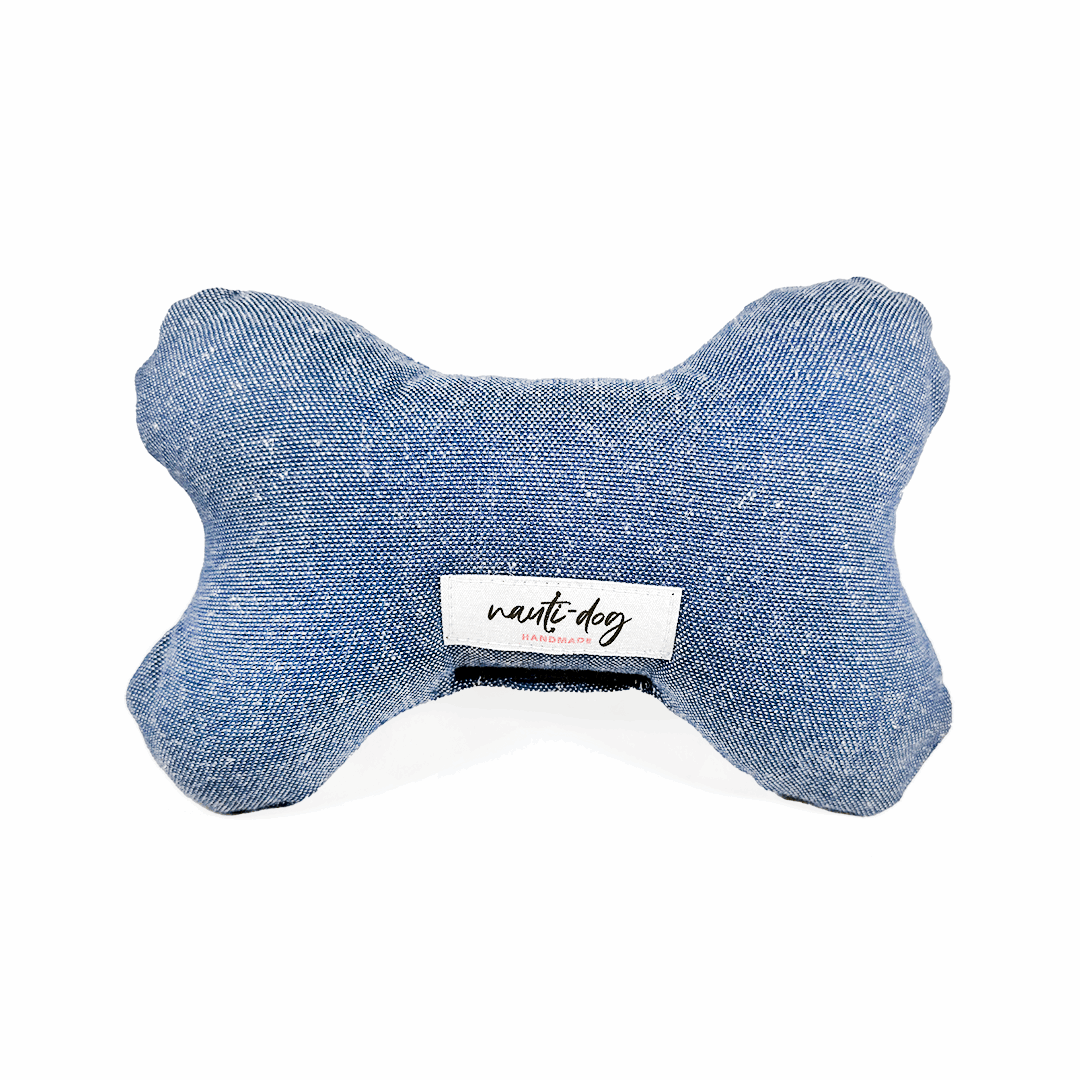 Blue bone-shaped dog toy with 'nauti-dog' label on a white background
