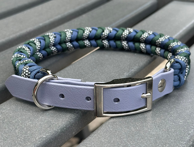 Dog collar with braided design and gray biothane strap on a gray surface
