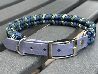 Dog collar with braided design and gray biothane strap on a gray surface