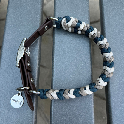 Dog collar with braided design and leather accents on a metal surface