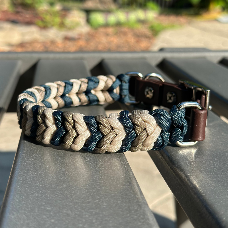 Dog collar with navy blue, tan, and cream braid, with medium brown biothane strap