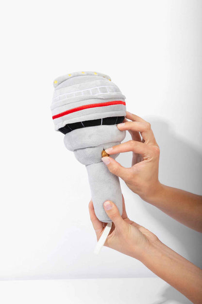 The Six Nose Work Dog Toy with woman's hands putting treat in toy on white background