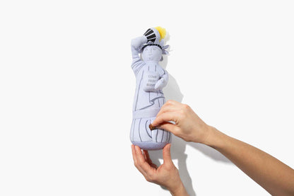 Liberty Nose Work Dog Toy with woman's hands putting treat in toy, on white background