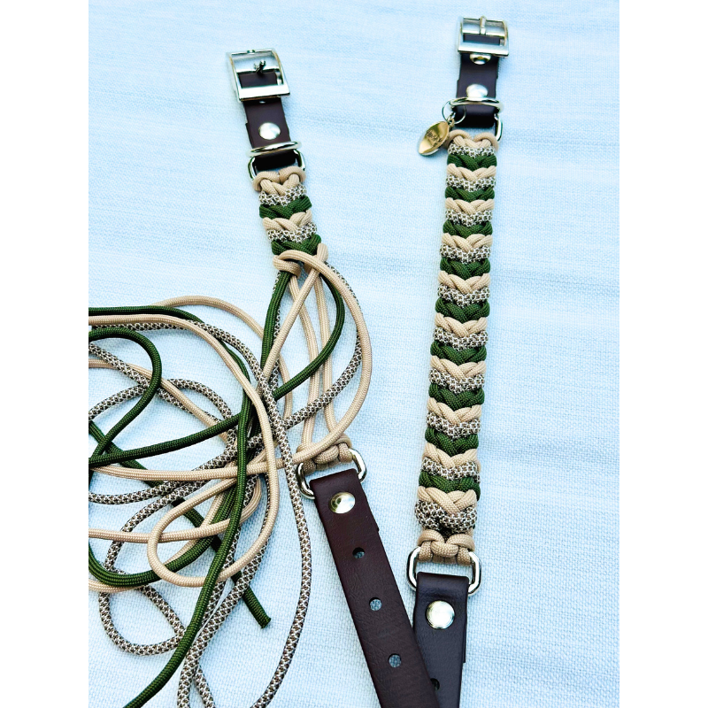 Two braided straps with metal buckles on a light blue background