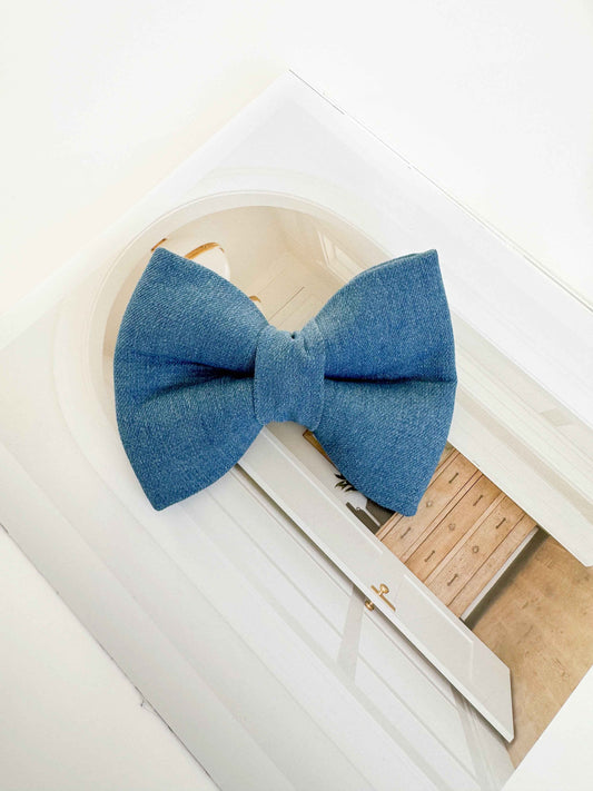 Denim blue dog bow on white background