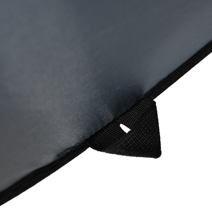 Close-up of a black umbrella with a white label on a white background