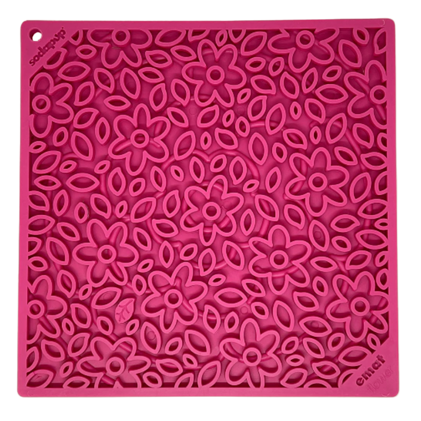 Pink silicone mat with floral pattern on a beige background