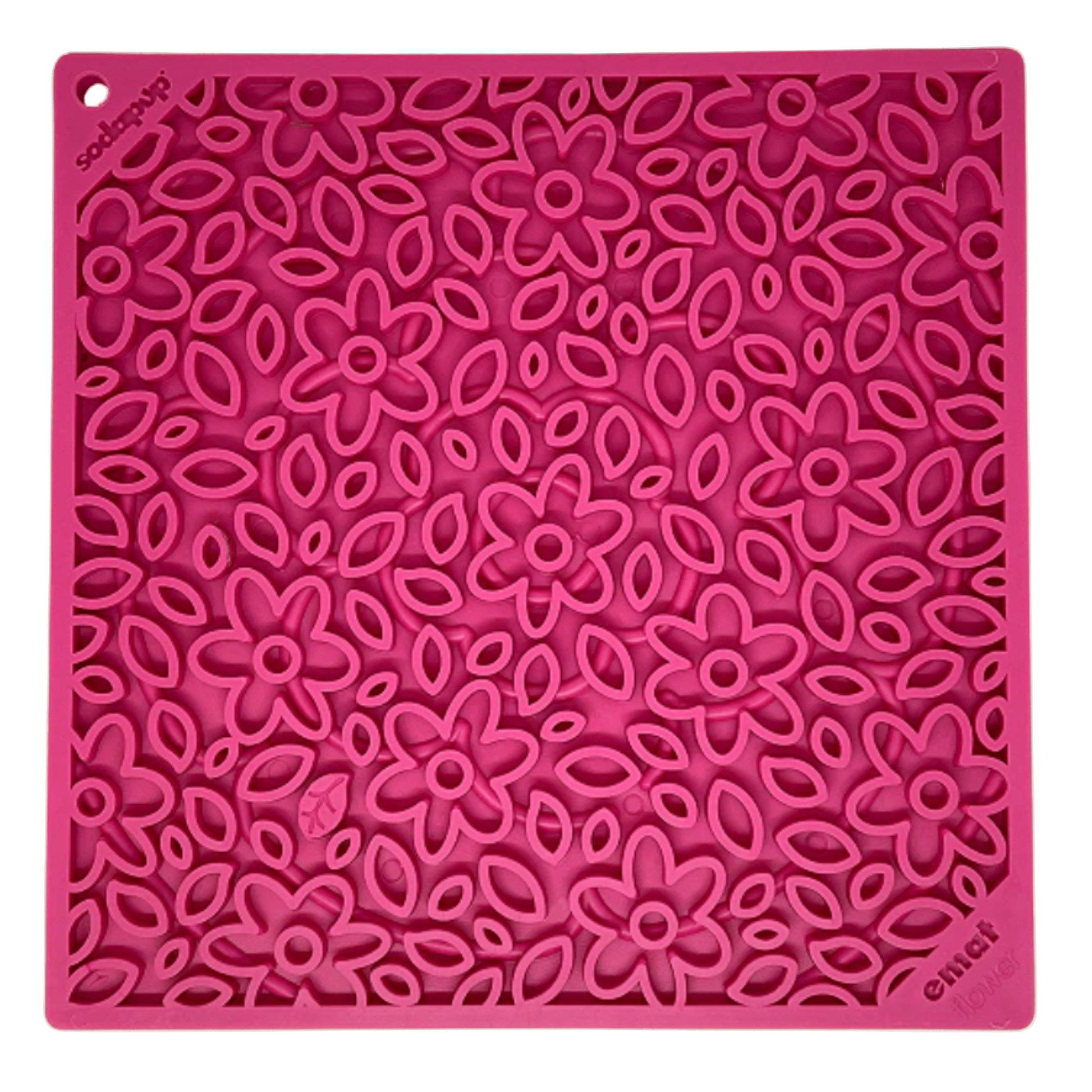 Pink silicone mat with floral pattern on a beige background