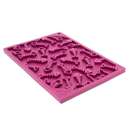 Pink silicone lick mat for dogs with fish skeletons on white background