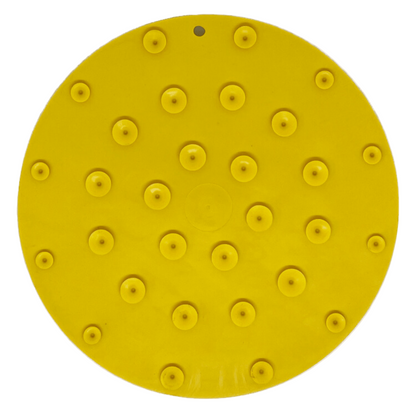 Yellow back of lick mat with suction cups on a white background