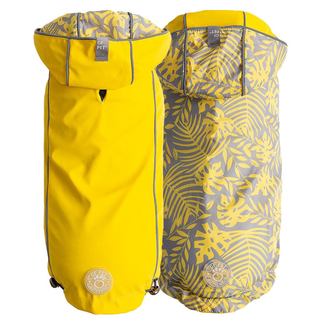 Reversible raincoats, one yellow and one with a leaf pattern, on a white background.