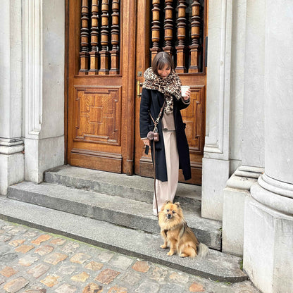 Hands Free Braided Leash on dog and woman standing in front of large wooden doors