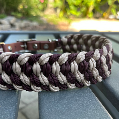 Dog collar with braided design in burgundy and light tan with medium brown BioThane strap on a gray surface outdoors.