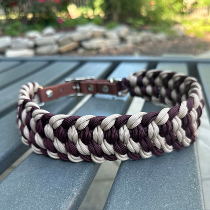 Dog collar with braided design in burgundy and light tan with medium brown BioThane strap on a gray surface outdoors.