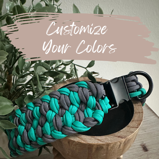 Paracord dog collar with teal and gray braided design on a wooden surface with plants in the background with caption customize your colors