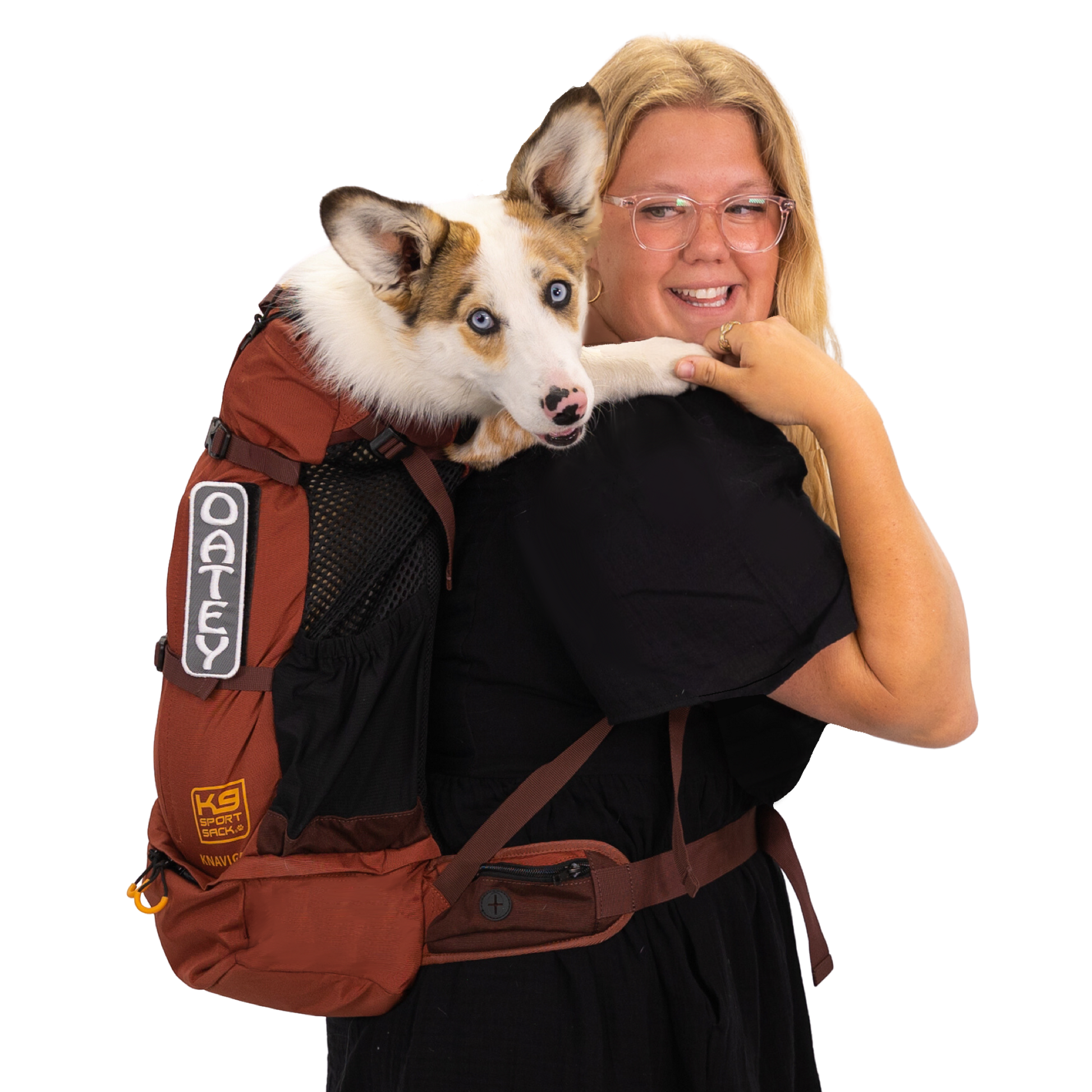 Woman holding a dog in a brown backpack with visible branding on a white background