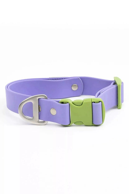 Purple dog collar with a green buckle on a white background