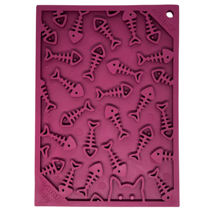 Pink silicone dog lick mat with fish skeleton designs on a white background