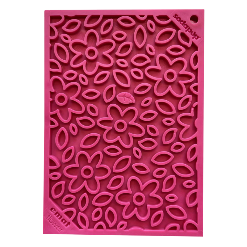Pink silicone dog lick mat with floral pattern on a white background