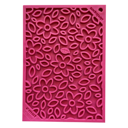 Pink silicone dog lick mat with floral pattern on a white background