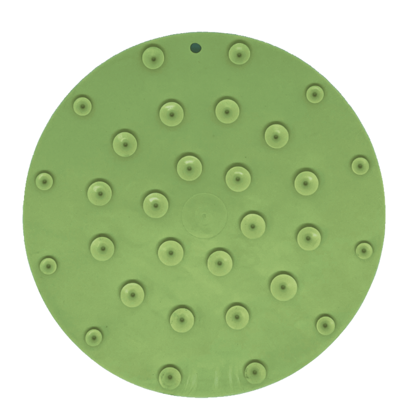 Green dog lick mat with suction cups on a white background